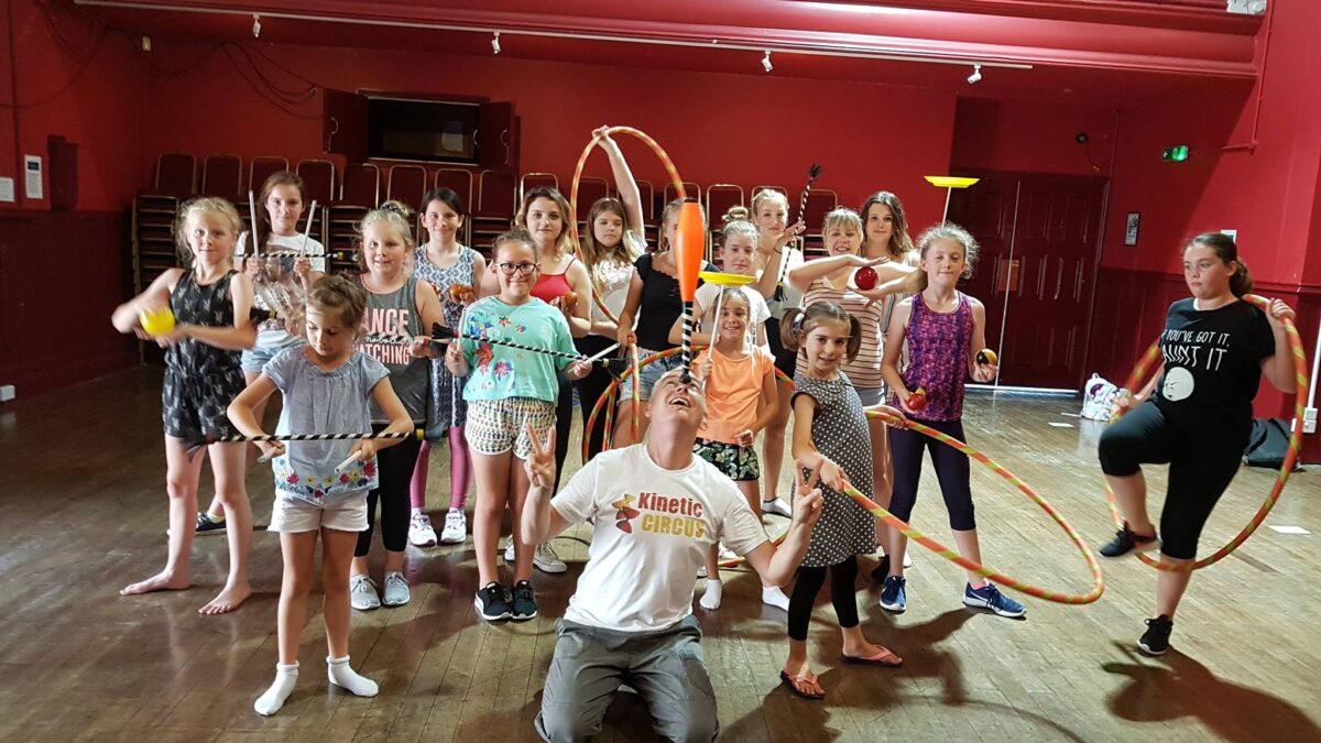 Group of children hula hooping at a circus birthday party by Kinetic Circus